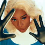 Vanniall in a Sue Storm costume holding out her gloved hands as though she is using her powers